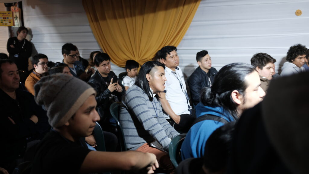 Audience seated together at an in-person event in Peru.